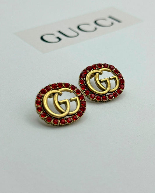 Arete Gucci oro viejo circular piedra roja