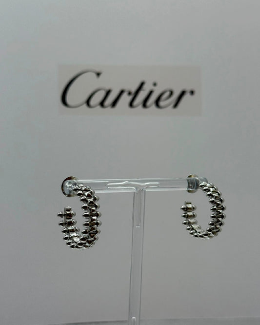 Arete Cartier dorado con picos plata